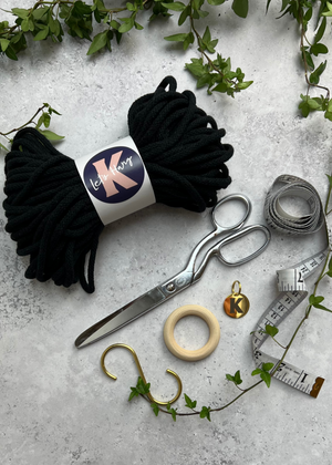 Charcoal Black Make your Own Macramé Plant Hanger kit contents; macramé thread, brass S hook, wooden macramé hoop, engraved brass Knotted tag, scissors and tape measure.
