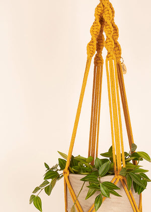 Close up of Twisted knot style in Mustard macramé Plant Hanger, handmade from 100% recycled cotton